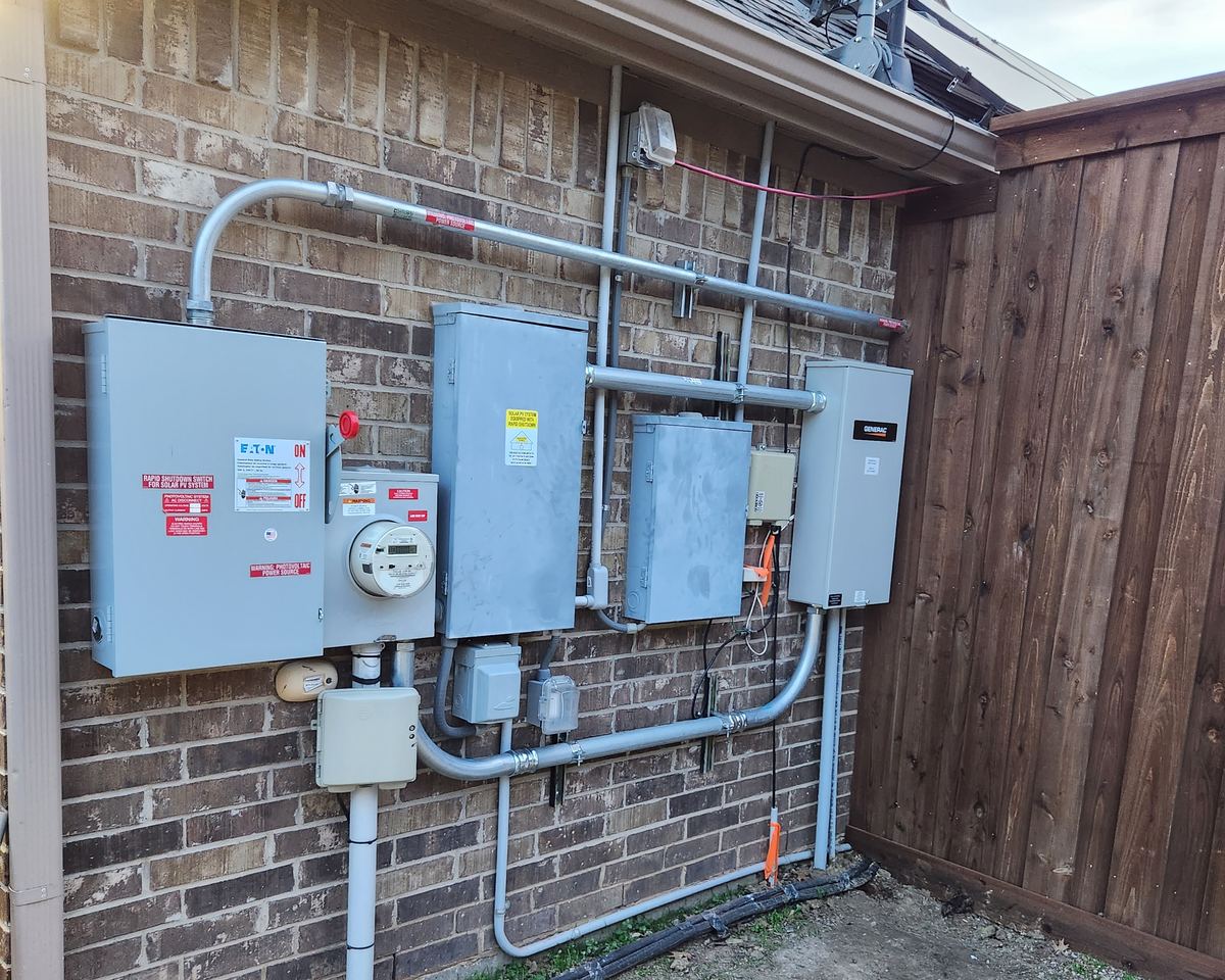Electrical disconnect switches, meter and transfer switch panels installed on an exterior wall